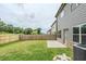 Large fenced backyard with a patio and green lawn at 2317 Church Street, Hampton, GA 30228