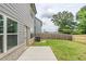 Fenced backyard with patio, lawn, and an air conditioning unit at 2317 Church Street, Hampton, GA 30228