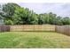 Spacious backyard with a well-maintained lawn and a wooden privacy fence at 2317 Church Street, Hampton, GA 30228