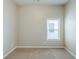 Well-lit bedroom features a window and neutral walls with carpet flooring at 2317 Church Street, Hampton, GA 30228