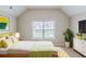Bright bedroom with window, hardwood furniture, and vaulted ceilings creating a calming space at 2317 Church Street, Hampton, GA 30228