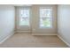 Cozy bedroom featuring neutral walls, carpeted floors, and windows for natural light at 2317 Church Street, Hampton, GA 30228