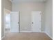 Carpeted bedroom with white doors and neutral tones; ideal for a relaxing retreat at 2317 Church Street, Hampton, GA 30228