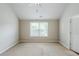 Spacious, neutral bedroom featuring carpet flooring, window and ceiling fan at 2317 Church Street, Hampton, GA 30228