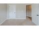 Bedroom featuring neutral walls, doors and carpeted floors that create a comfortable space at 2317 Church Street, Hampton, GA 30228
