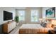 Bright bedroom with neutral walls, hardwood furniture, and windows providing natural light at 2317 Church Street, Hampton, GA 30228