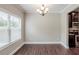 Bright dining room featuring hardwood floors, natural light, and modern chandelier at 2317 Church Street, Hampton, GA 30228
