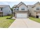 Charming two-story home featuring a brick-accented garage and well-maintained front lawn at 2317 Church Street, Hampton, GA 30228