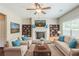 Cozy living room with fireplace, ceiling fan, and built in bookcases perfect for entertaining at 2317 Church Street, Hampton, GA 30228