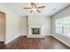 Spacious living room with neutral walls, fireplace, window, and dark wood flooring at 2317 Church Street, Hampton, GA 30228