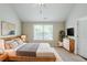Cozy main bedroom with decor, a large window, and natural lighting at 2317 Church Street, Hampton, GA 30228