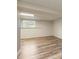 Spacious basement area with wood-look flooring and bright lighting at 319 Hill Crest Cir, Woodstock, GA 30188