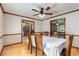Spacious dining room with wood floors and wainscotting, and a view into the living room and kitchen at 319 Hill Crest Cir, Woodstock, GA 30188