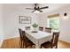 Bright dining room with wood floors and a 'gather' sign over the wainscotting, and table set for six at 319 Hill Crest Cir, Woodstock, GA 30188