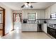 Clean kitchen featuring white cabinets, stainless steel appliances, tile backsplash, and a door to the back at 319 Hill Crest Cir, Woodstock, GA 30188