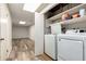 Convenient laundry area with modern appliances and storage shelving at 319 Hill Crest Cir, Woodstock, GA 30188