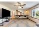 Spacious living room with a large window, ceiling fan, and open access to the split level in the home at 319 Hill Crest Cir, Woodstock, GA 30188
