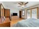 Main bedroom featuring a ceiling fan, wood floors, and natural light from a sliding glass door at 319 Hill Crest Cir, Woodstock, GA 30188