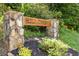 Stone and wood sign reading 'Hill Crest' with greenery, marking the entrance to the neighborhood at 319 Hill Crest Cir, Woodstock, GA 30188
