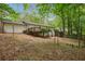 Large backyard featuring a deck, wooded area, and storage shed at 3455 Broxton Mill Way, Snellville, GA 30039