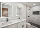 Modern bathroom featuring a double vanity, sleek mirrors, and a stand-up shower with black hardware at 3455 Broxton Mill Way, Snellville, GA 30039