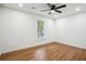 Bright bedroom with hardwood flooring, white walls, a modern ceiling fan and a large window at 3455 Broxton Mill Way, Snellville, GA 30039