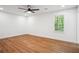 Bright bedroom with hardwood flooring, white walls, a modern ceiling fan and a large window at 3455 Broxton Mill Way, Snellville, GA 30039