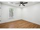 Bright and airy bedroom featuring modern floors, a ceiling fan, and large windows with natural light at 3455 Broxton Mill Way, Snellville, GA 30039