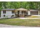 Beautifully renovated house featuring a charming front porch, new paint, and manicured landscaping at 3455 Broxton Mill Way, Snellville, GA 30039