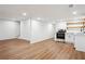 Open-concept living room with hardwood floors that leads to a kitchen with stainless steel appliances at 3455 Broxton Mill Way, Snellville, GA 30039