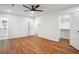Spacious main bedroom featuring hardwood floors, a ceiling fan, ensuite bathroom, and walk-in closet at 3455 Broxton Mill Way, Snellville, GA 30039