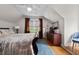 Comfortable bedroom with hardwood floors, a ceiling fan, and natural light from the window at 64 Edwin Nw, Atlanta, GA 30318