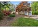 Charming two-story home with a well-manicured front yard, garden, and attached two-car garage at 64 Edwin Nw, Atlanta, GA 30318