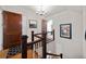 Bright hallway featuring hardwood floors, stairs, and a decorative chandelier at 64 Edwin Nw, Atlanta, GA 30318