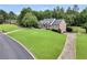 Wide aerial view of the lovely lawn, home, and surrounding greenery at 704 Branchview Ct, Mcdonough, GA 30252