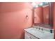 This powder room features a white vanity and a decorative mirror at 704 Branchview Ct, Mcdonough, GA 30252