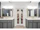 Modern bathroom featuring and vanities and an adjacent doorway to the main bedroom at 704 Branchview Ct, Mcdonough, GA 30252
