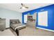 Stylish bedroom with blue accent wall, shutters, and built in drawer unit at 704 Branchview Ct, Mcdonough, GA 30252