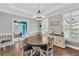 Dining room, adjacent to the playroom, with hardwood floors and abundant natural light at 704 Branchview Ct, Mcdonough, GA 30252