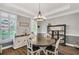 Elegant dining room featuring hardwood floors, chandelier lighting, and stylish decor at 704 Branchview Ct, Mcdonough, GA 30252