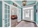 Bright foyer featuring hardwood floors, a decorative front door, and access to the living room at 704 Branchview Ct, Mcdonough, GA 30252