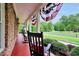 Welcoming front porch with rocking chairs and patriotic bunting at 704 Branchview Ct, Mcdonough, GA 30252