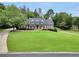Expansive front yard with well-maintained lawn and mature trees leading to a classic brick home at 704 Branchview Ct, Mcdonough, GA 30252