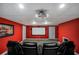 A cozy home theater with comfortable black leather seating and a projection screen for movie nights at 704 Branchview Ct, Mcdonough, GA 30252
