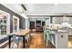 Open-concept kitchen and living area with hardwood floors and stainless steel appliances at 704 Branchview Ct, Mcdonough, GA 30252