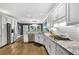 Modern kitchen features white cabinets, stainless steel appliances and marble countertops at 704 Branchview Ct, Mcdonough, GA 30252