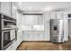 Gourmet kitchen features stainless appliances, custom cabinetry and marble countertops at 704 Branchview Ct, Mcdonough, GA 30252