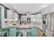 Modern kitchen features white cabinetry, stainless steel appliances and marble countertops at 704 Branchview Ct, Mcdonough, GA 30252