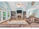 Spacious living room features a fireplace, large windows and hardwood floors at 704 Branchview Ct, Mcdonough, GA 30252