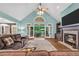 Open living room featuring hardwood floors, fireplace, built-in shelves and French doors to the patio at 704 Branchview Ct, Mcdonough, GA 30252